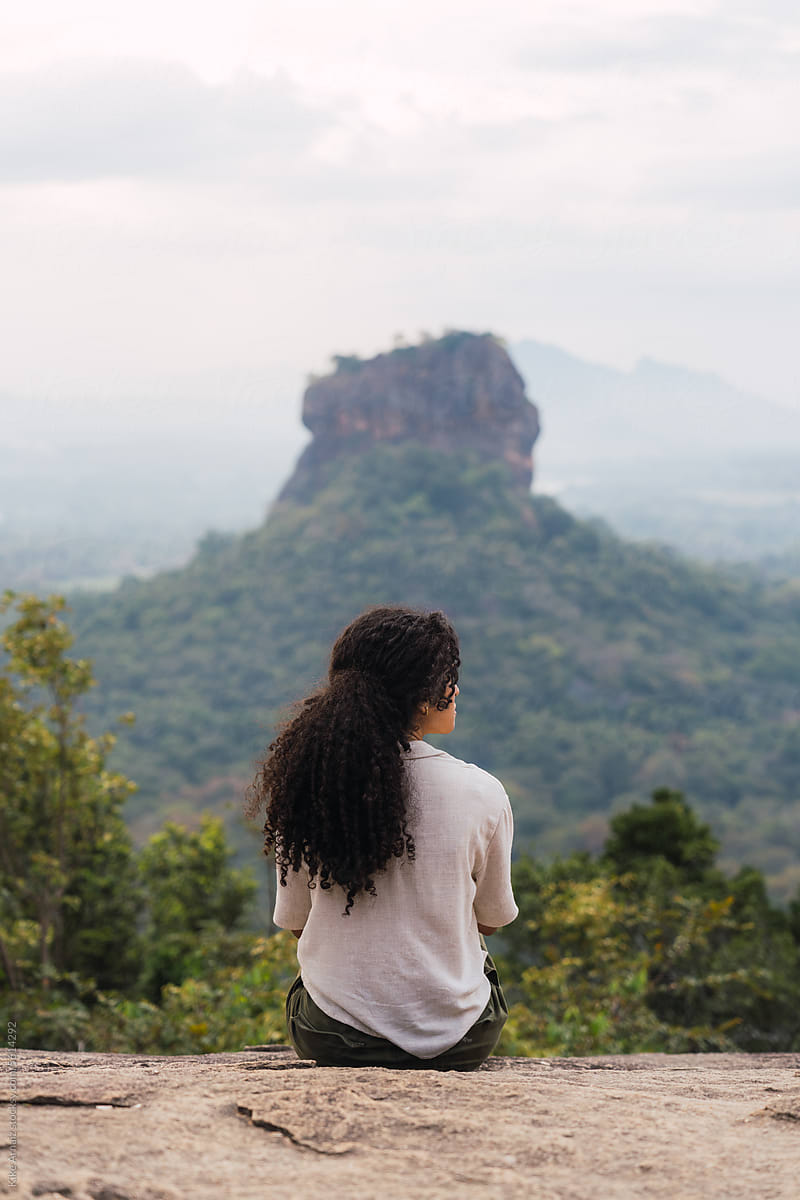 Woman contemplating Sigiriya rock.