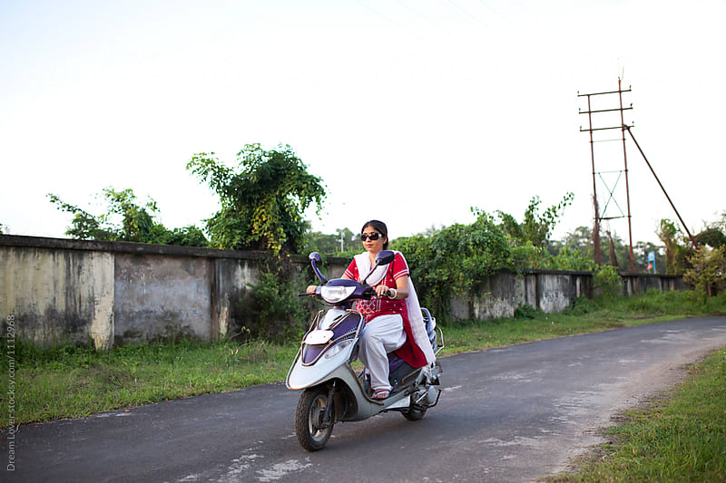Indian woman riding gearless two wheeler
