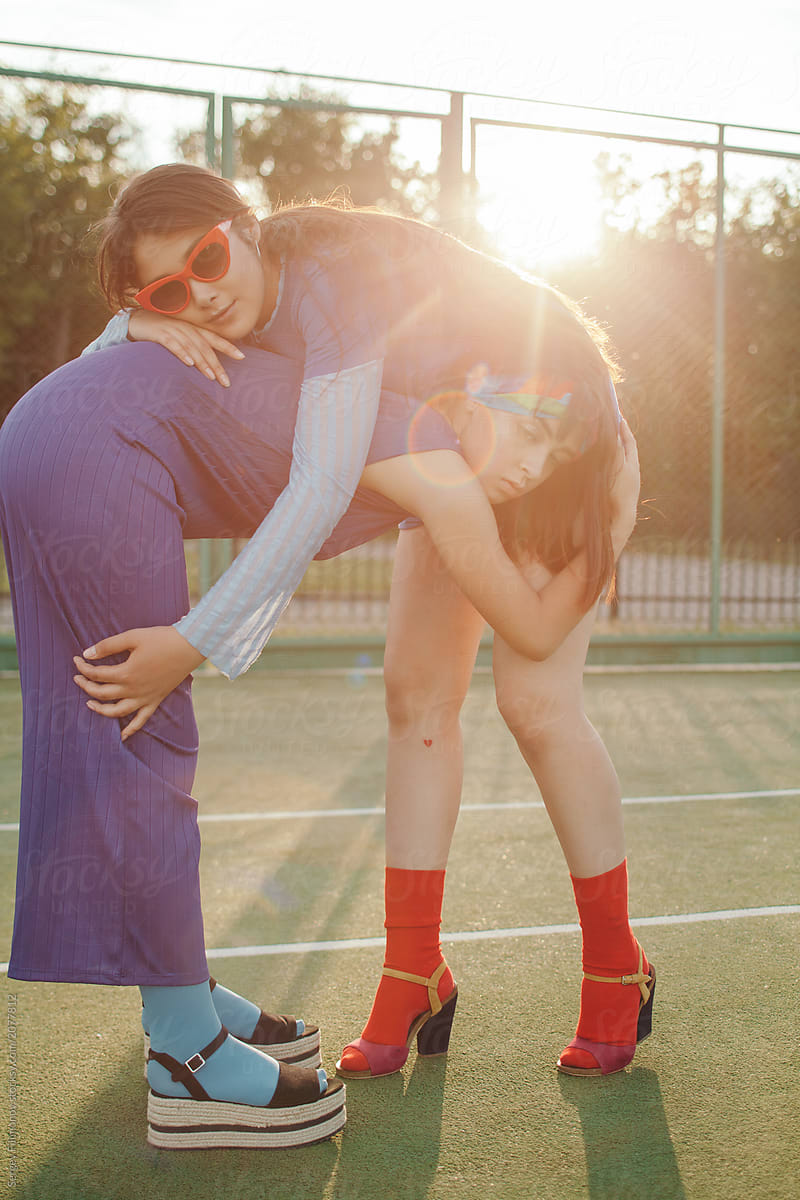 Relaxed Asian women posing on sports ground