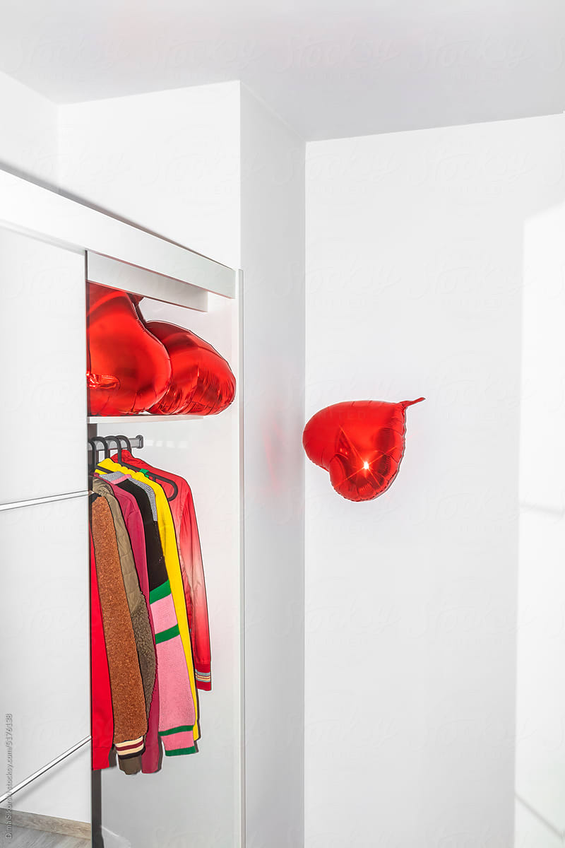 A heart-shaped balloon fell out of an overflowing closet