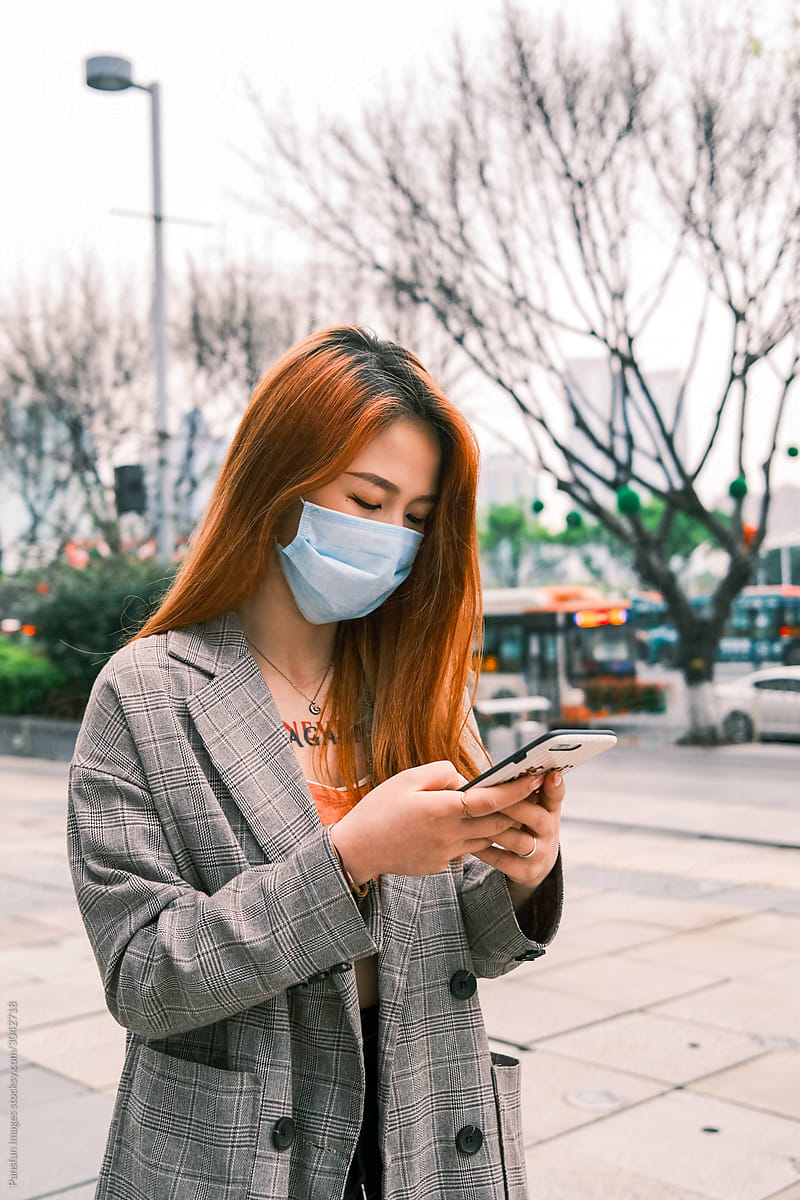 Young business woman wearing medical protective mask on the street
