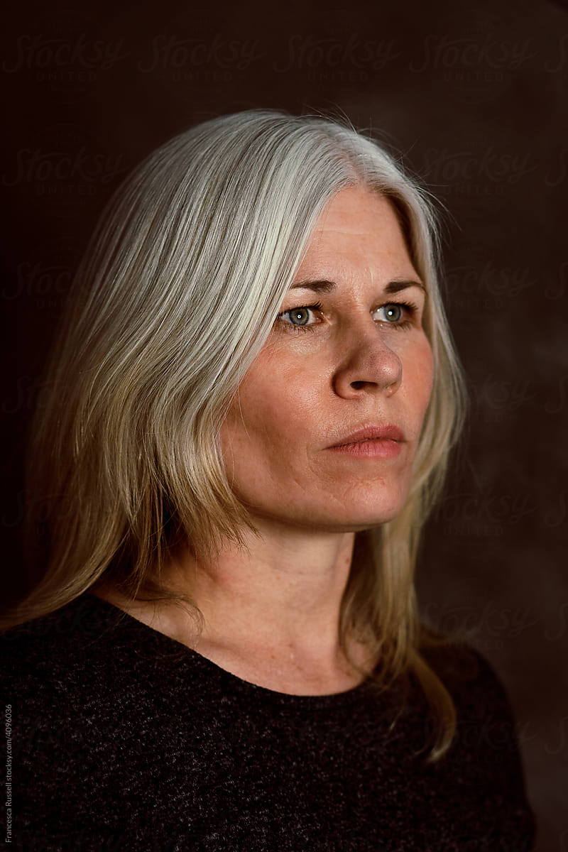 A portrait of a younger woman with gray hair.