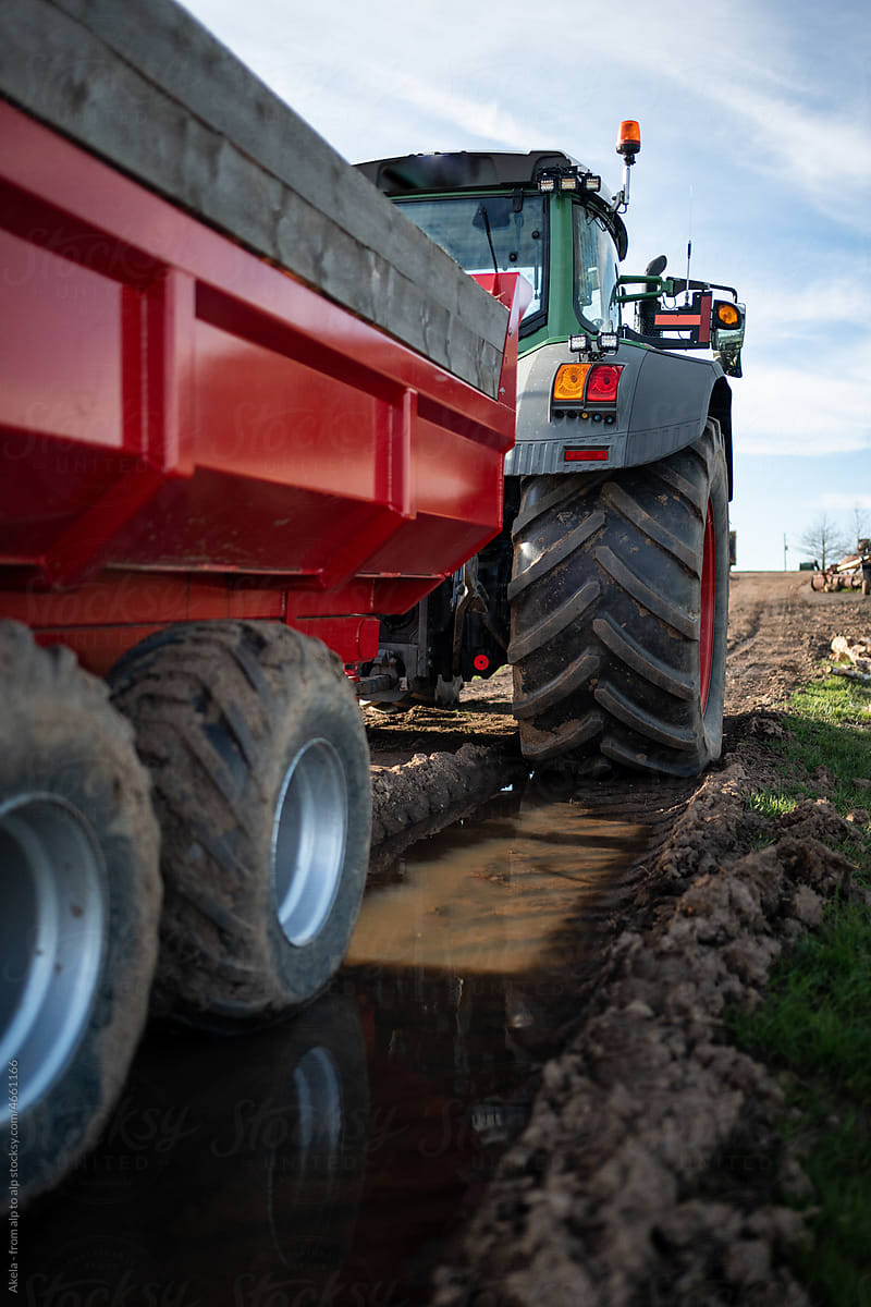 close up of tractor on mud road