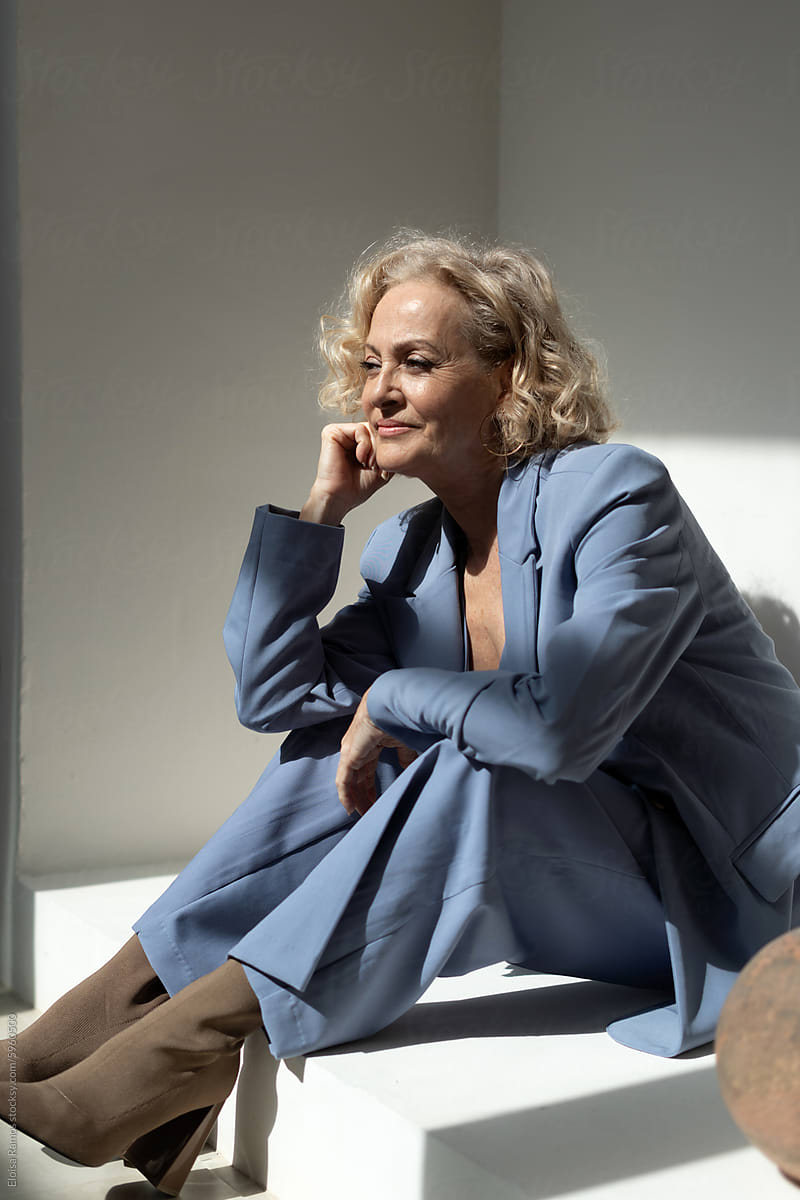 Contemplative Senior Woman in Blue Suit