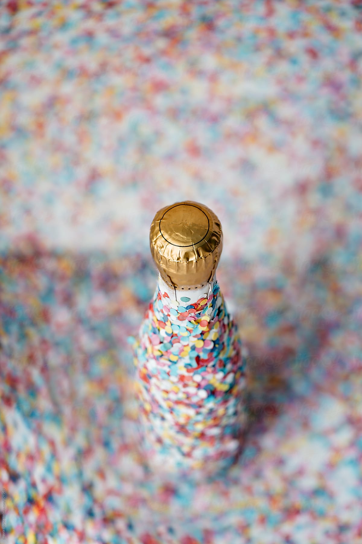 One bottle of champagne covered with confetti