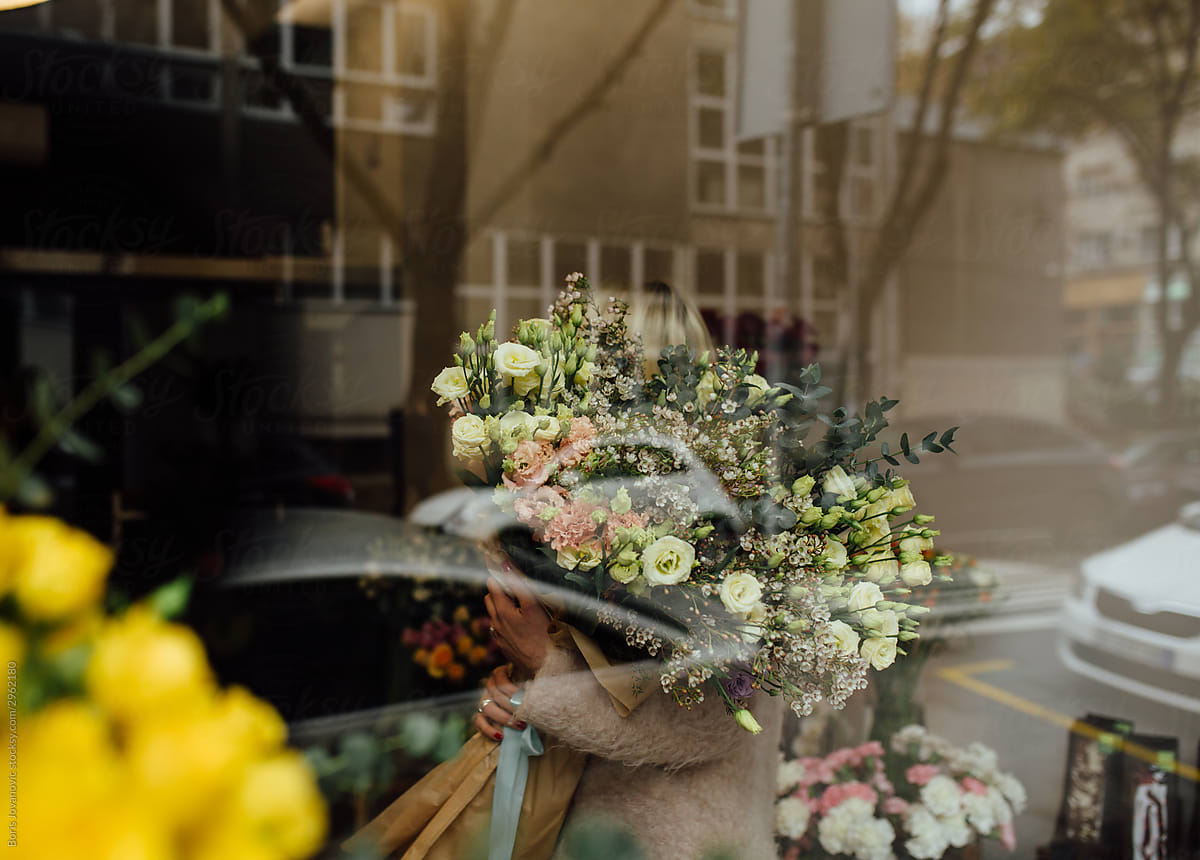 A Photo Of A Girl In A Flower Shop Holding A Huge Beautifully Arranged Flower Bouquet