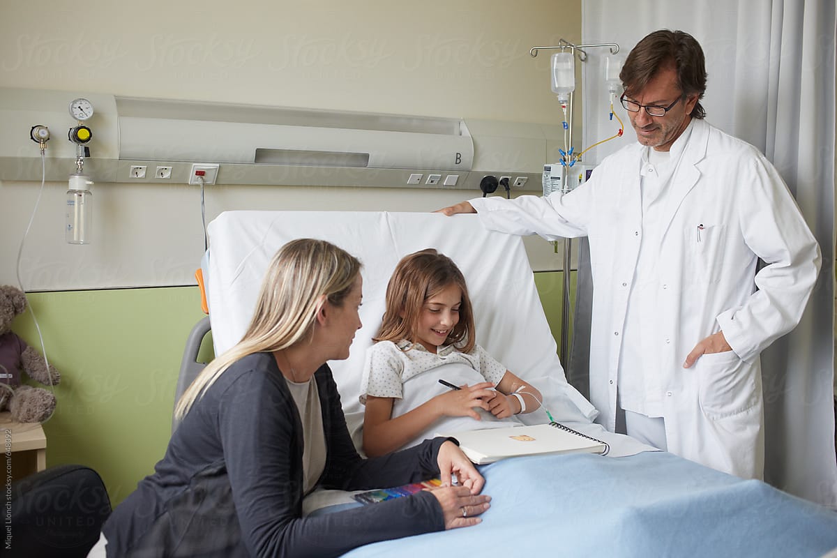Relaxed moment in a hospital room with child patient and doctor