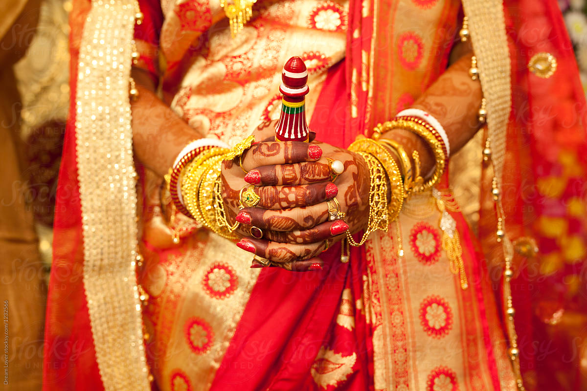 Decorative hand smudged with mehendi of a Hindu Bride in marriage ceremony