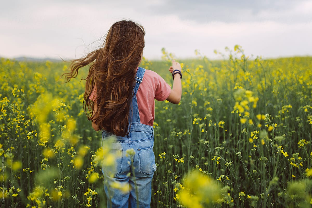Girl Standing In A Field. by Dejan Ristovski
