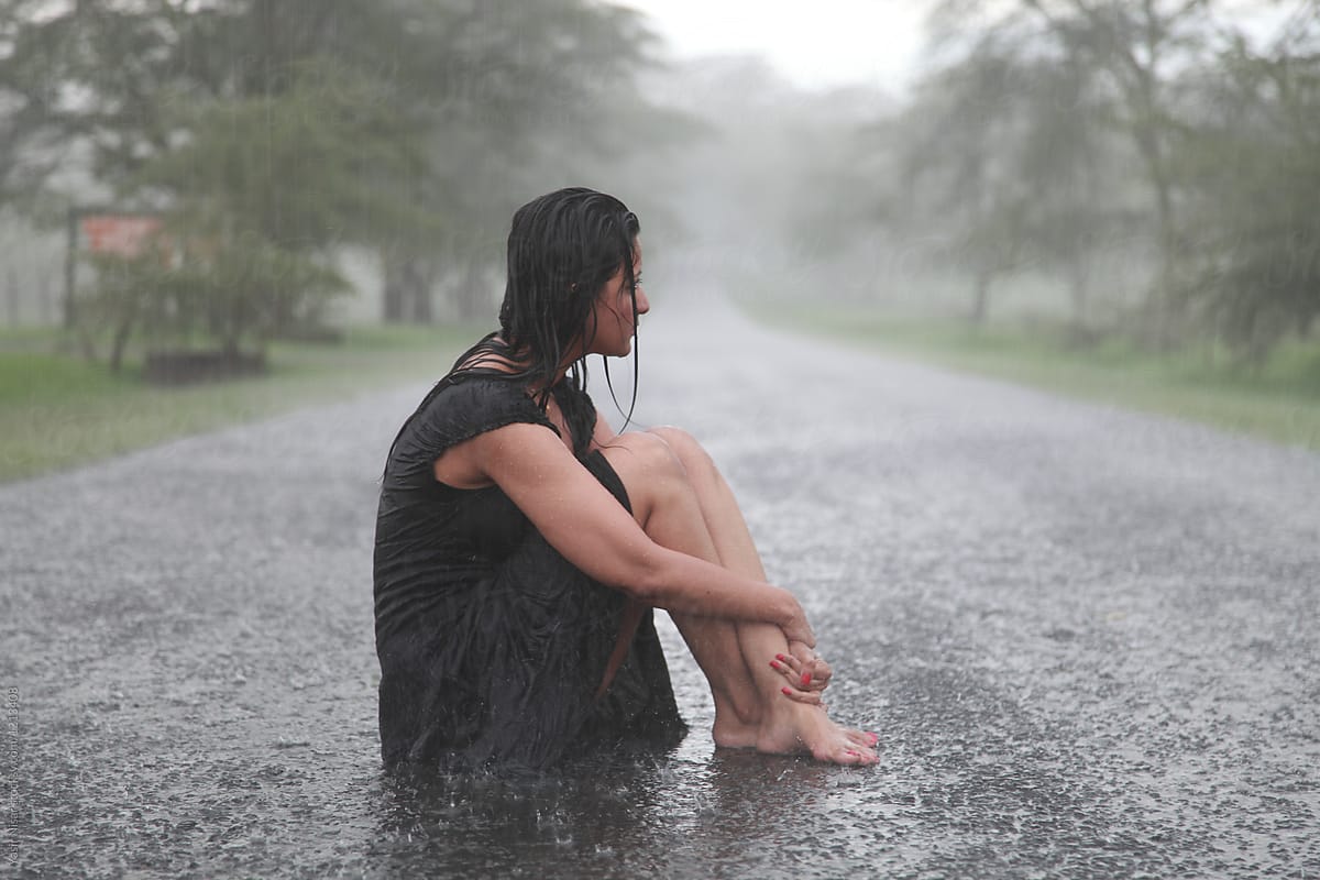 Woman Sitting Enjoying The Rain By Stocksy Contributor Yasir Nisar