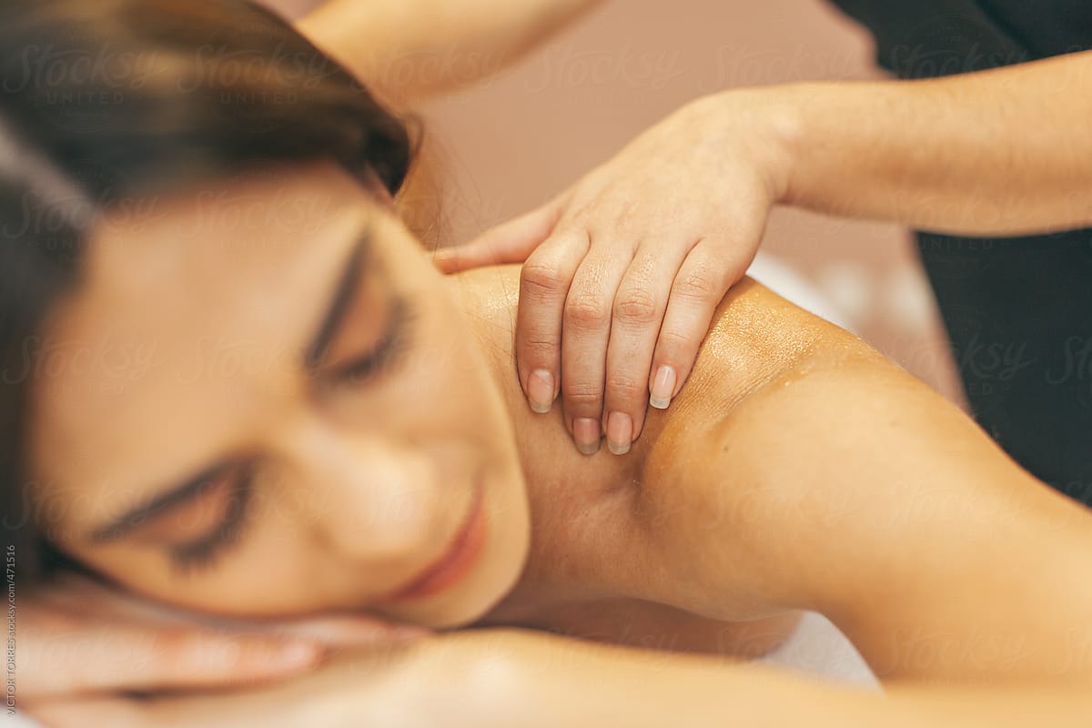Woman Enjoying A Back Massage By Stocksy Contributor Victor Torres