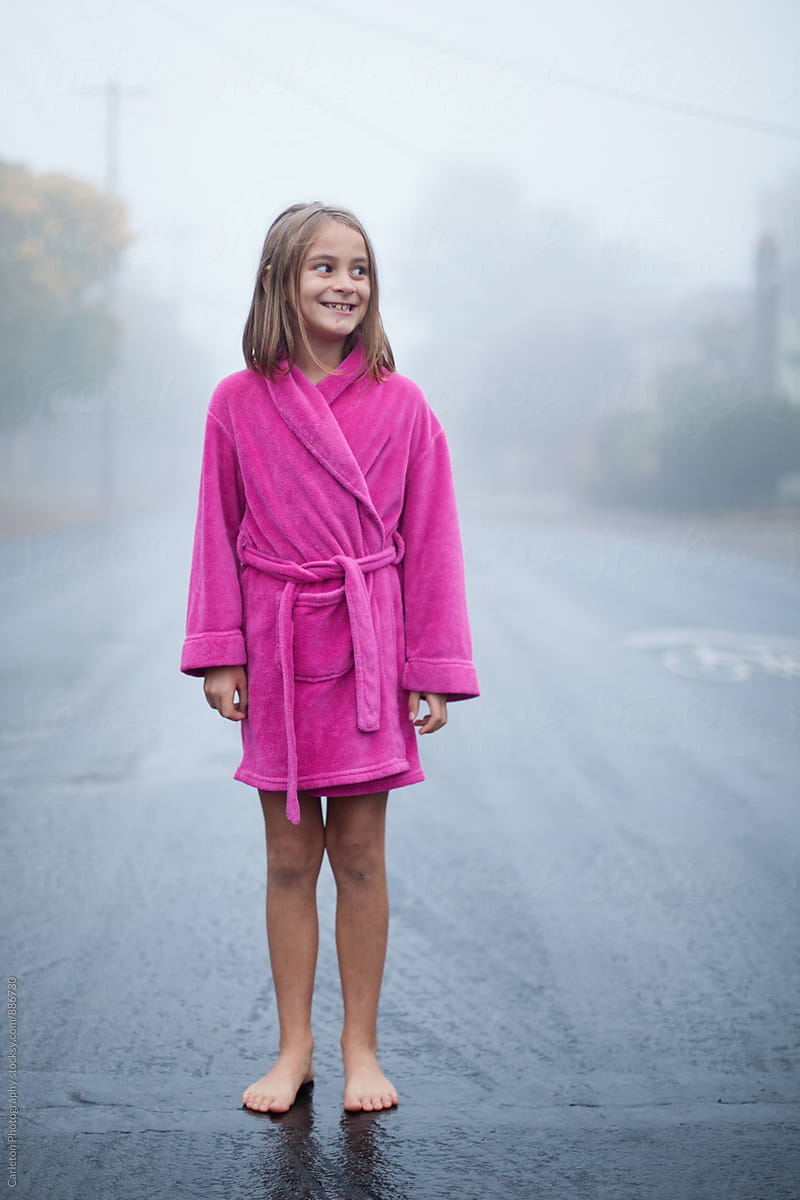 Barefoot Girl In Pink Bathrobe Stands On A Wet Street On A Foggy 5701