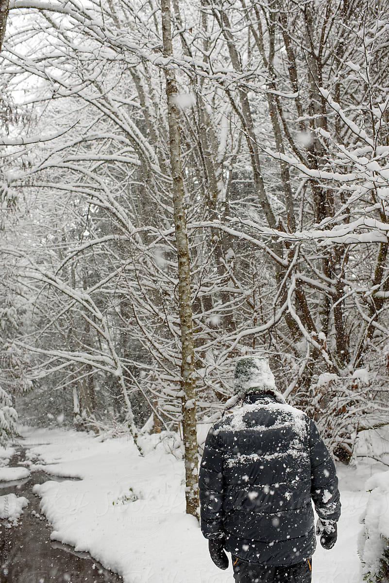 Man walking in the snowy forest