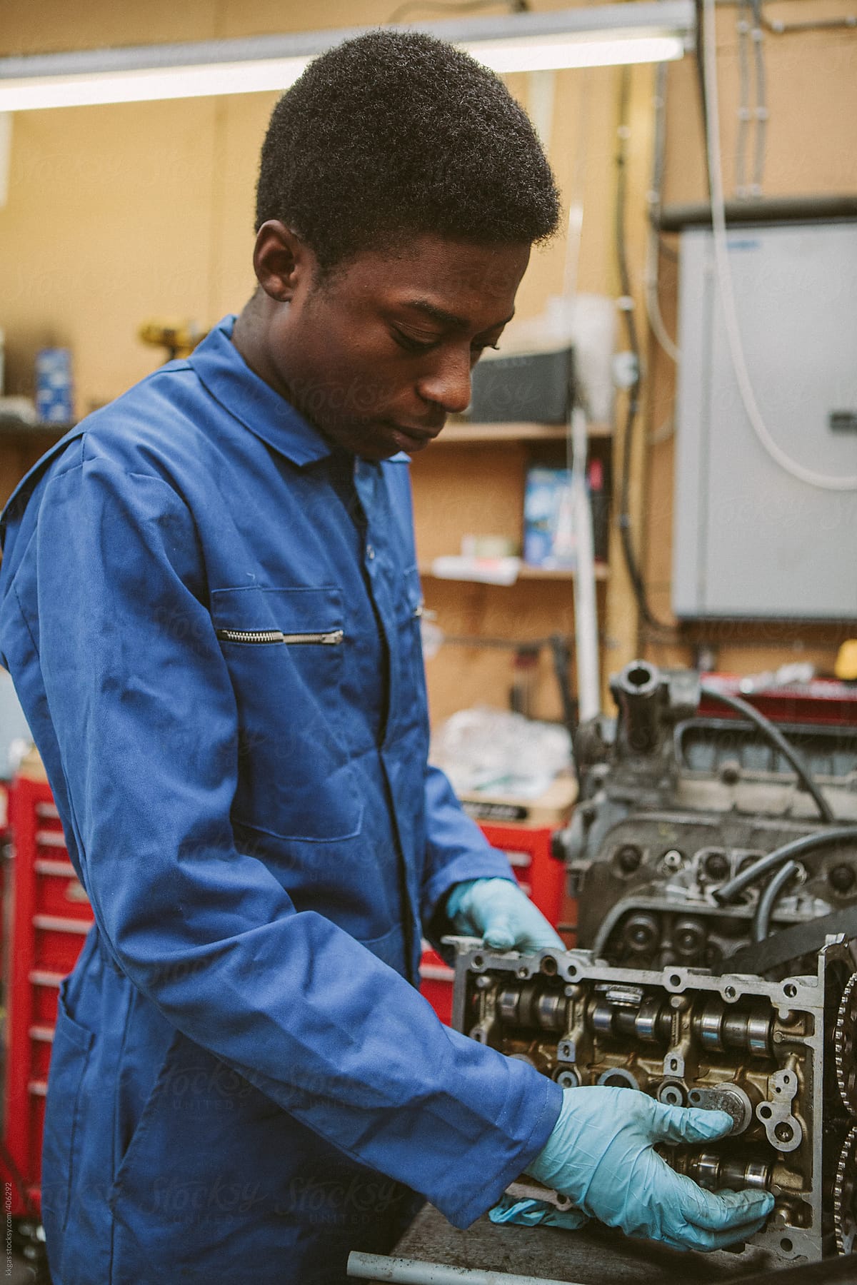 Young mechanic repairing an engine