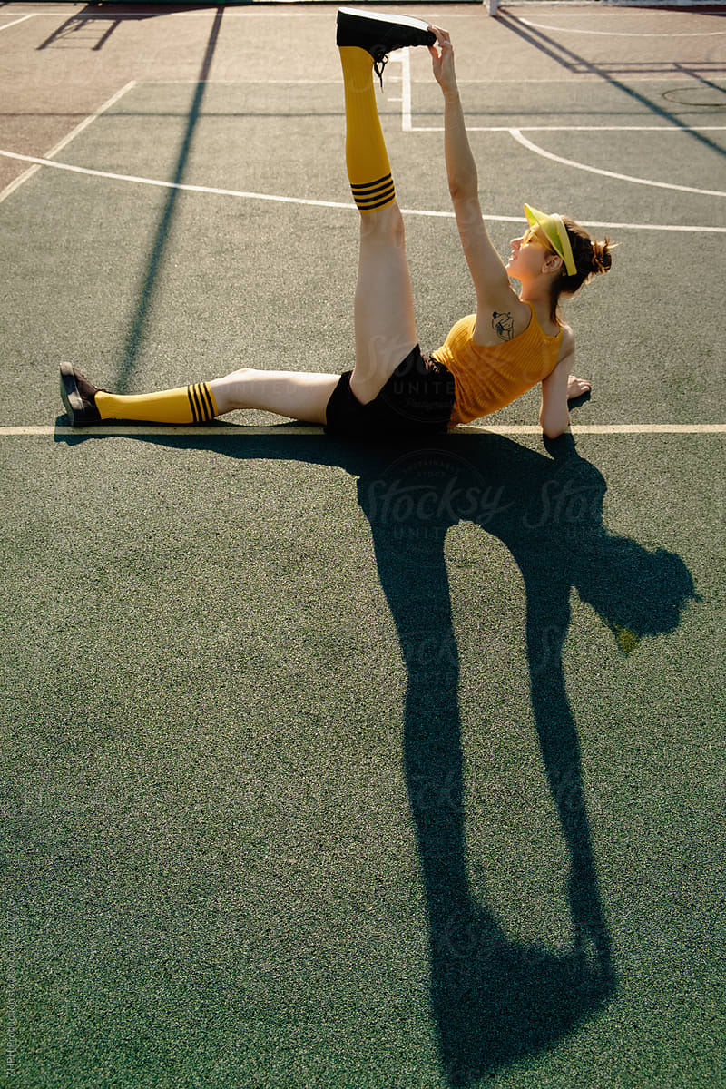 Young woman in trendy sportswear on the playground