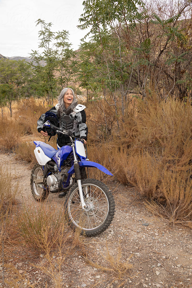 Mature woman outdoors on a dirtbike
