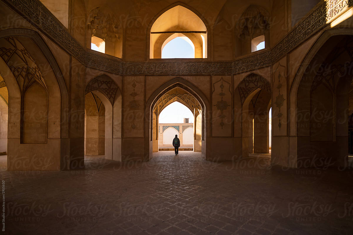 Person walking in Middle Eastern hall
