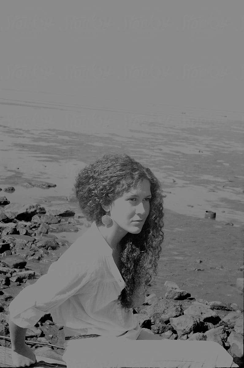 Calm beautiful curly woman on a beach