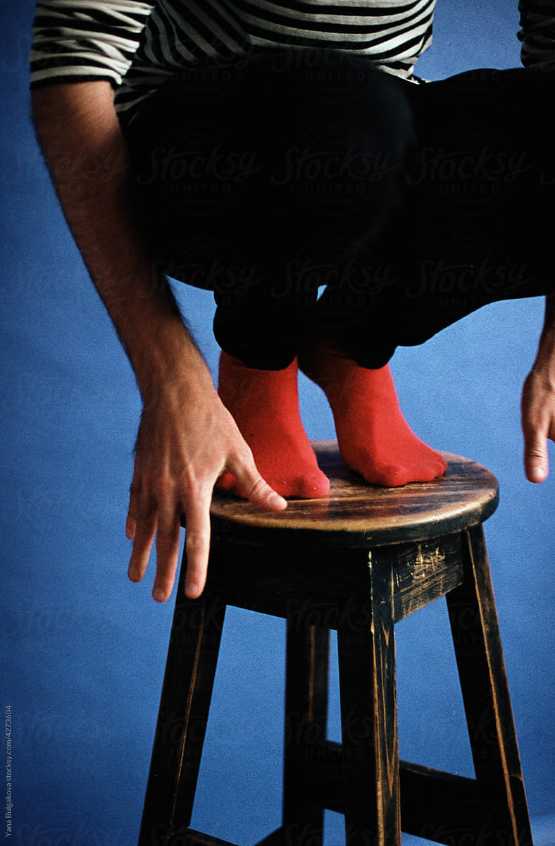 Young man sitting on the chair in studio