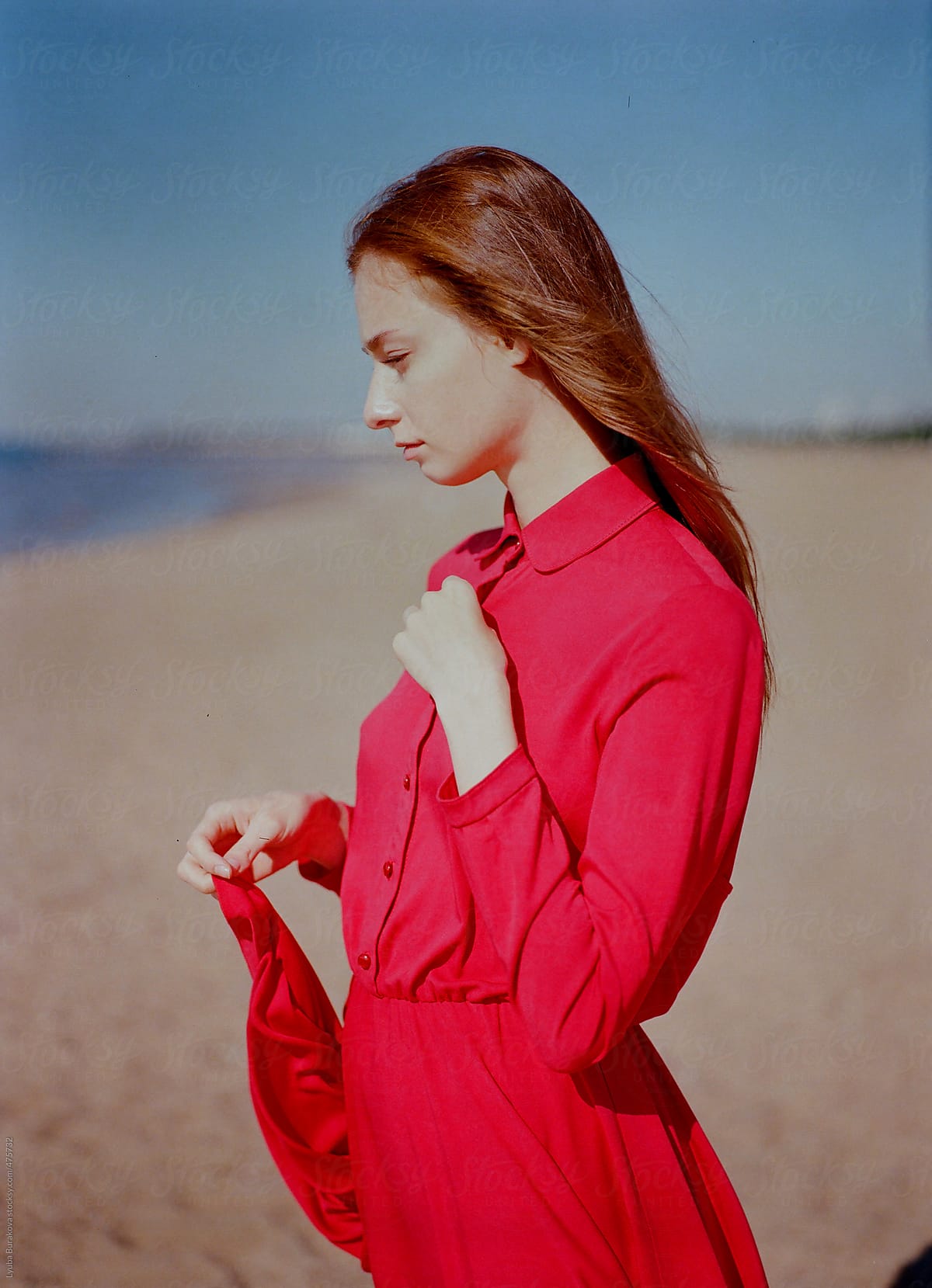 Portrait Of The Beautiful Woman In Red Dress Looking Away Del