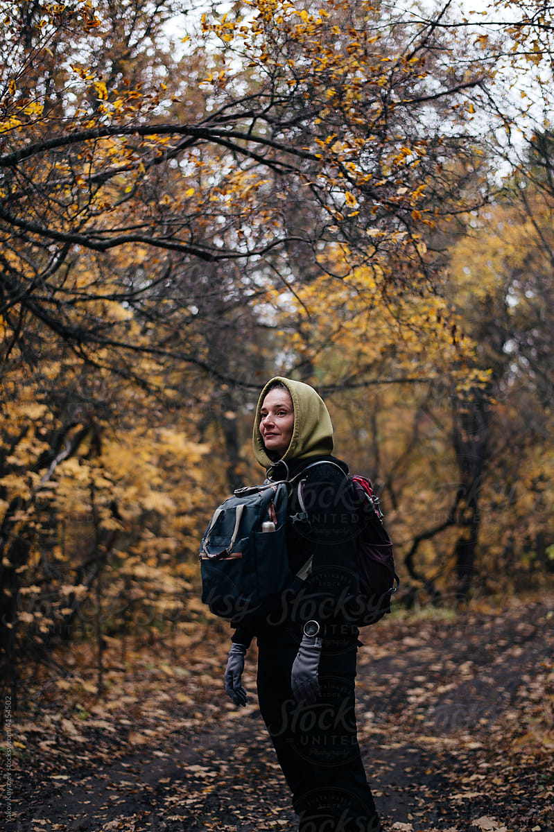 Young female hiking in the autumn forest