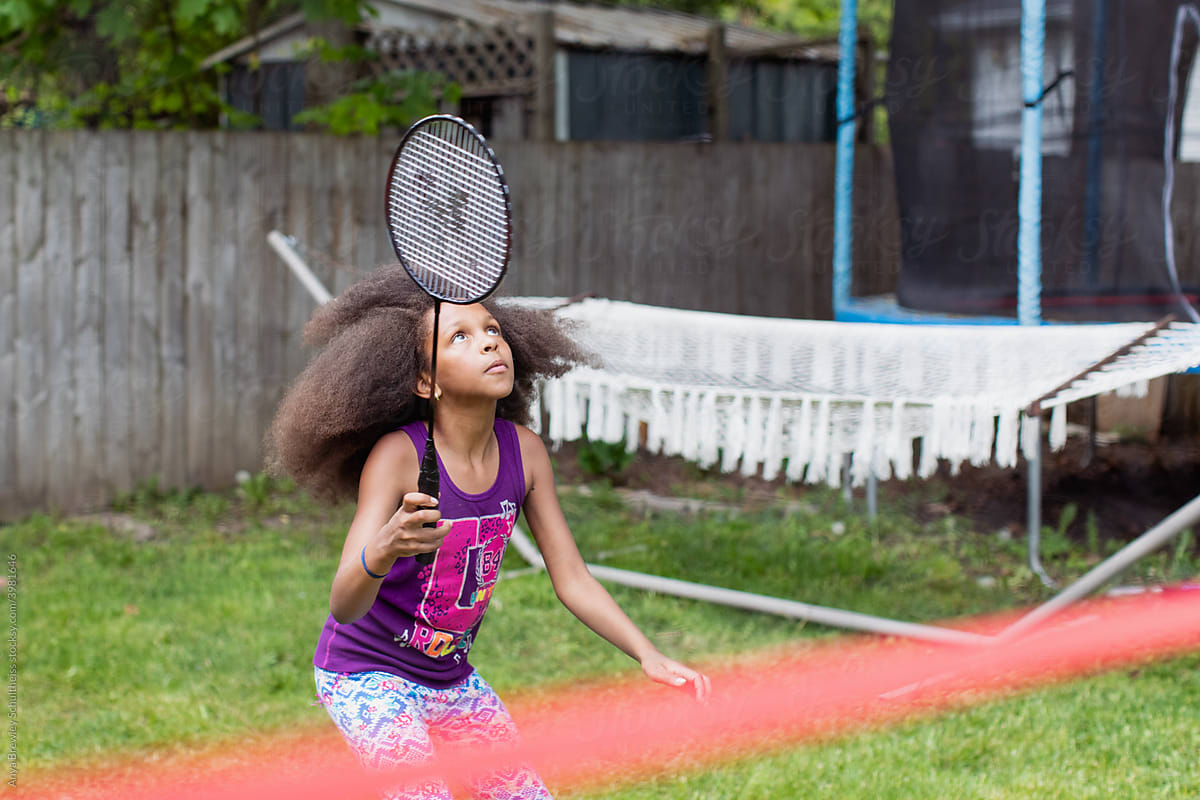 Young girl playing badminton with a racket