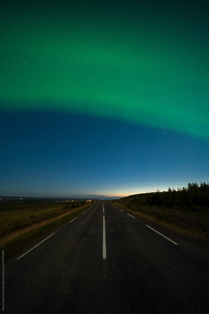Aurora Borealis, Northern Lights Over empty road In Iceland