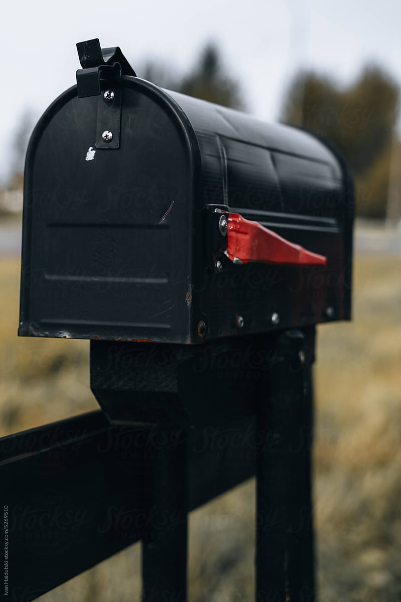 Black Rural Mailbox. The red lowered flag to show mail is not in.