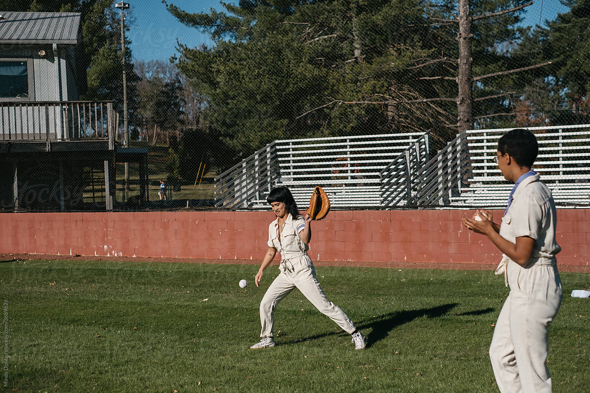 Young women playing catch on a baseball field