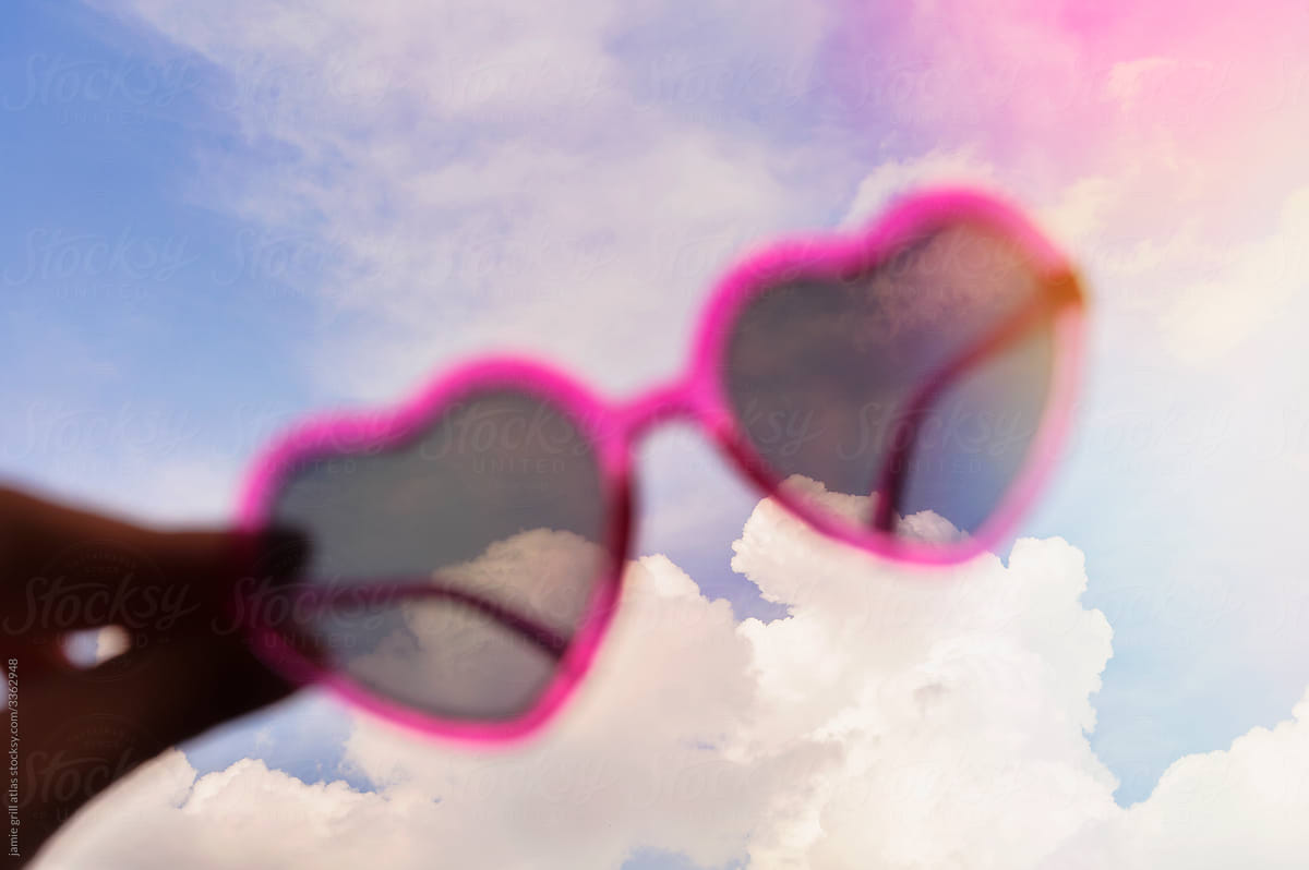Heart Sunglasses in front of Fluffy Clouds
