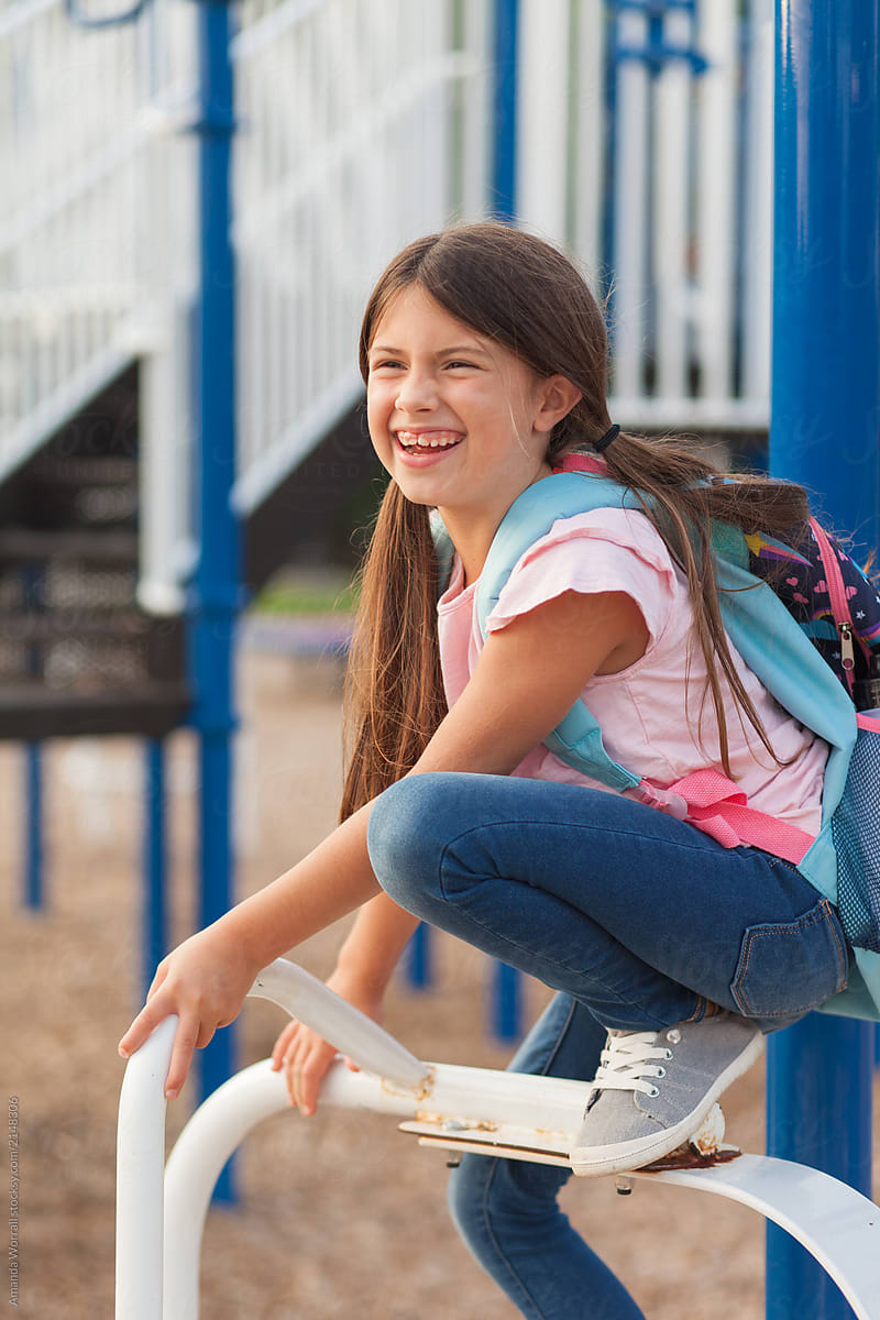 Cute Young Girl Smiling On The School Playground By Stocksy 