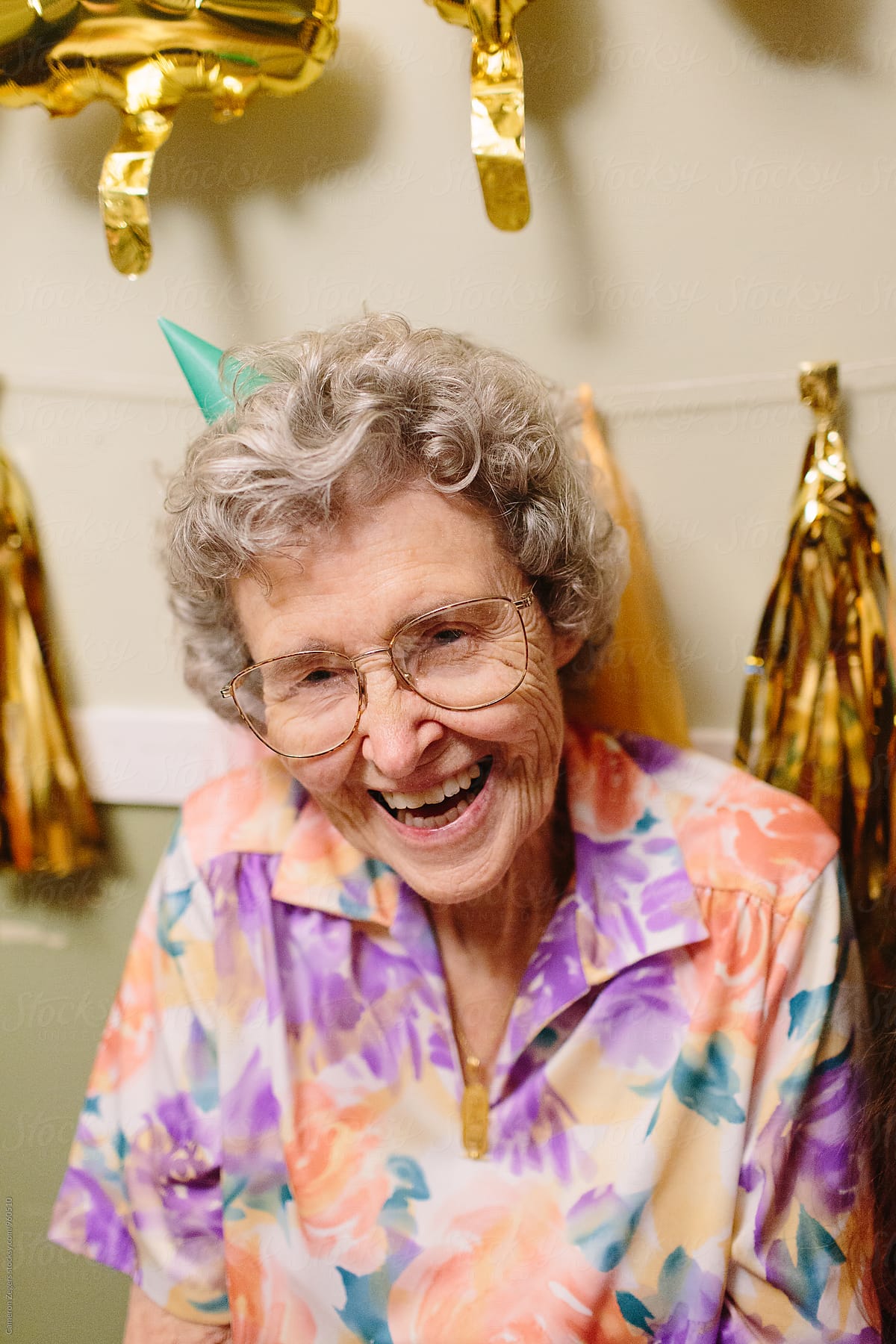 Elderly Woman Smiling Wearing Birthday Hat by Stocksy Contributor