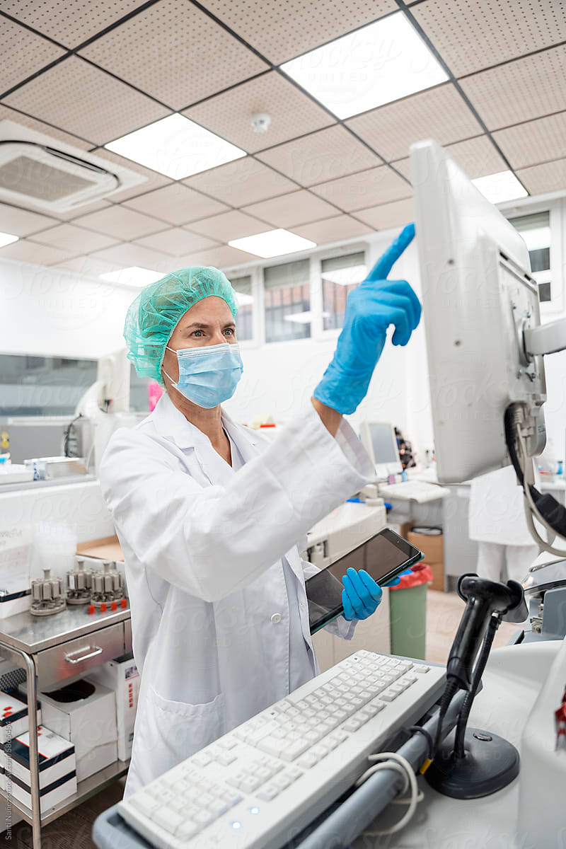 scientist woman operating machine in laboratory