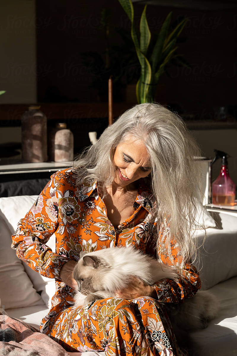 Mature woman with cat at home