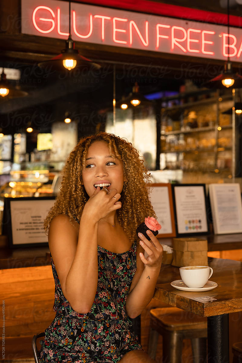 Cheerful woman sitting in cafe