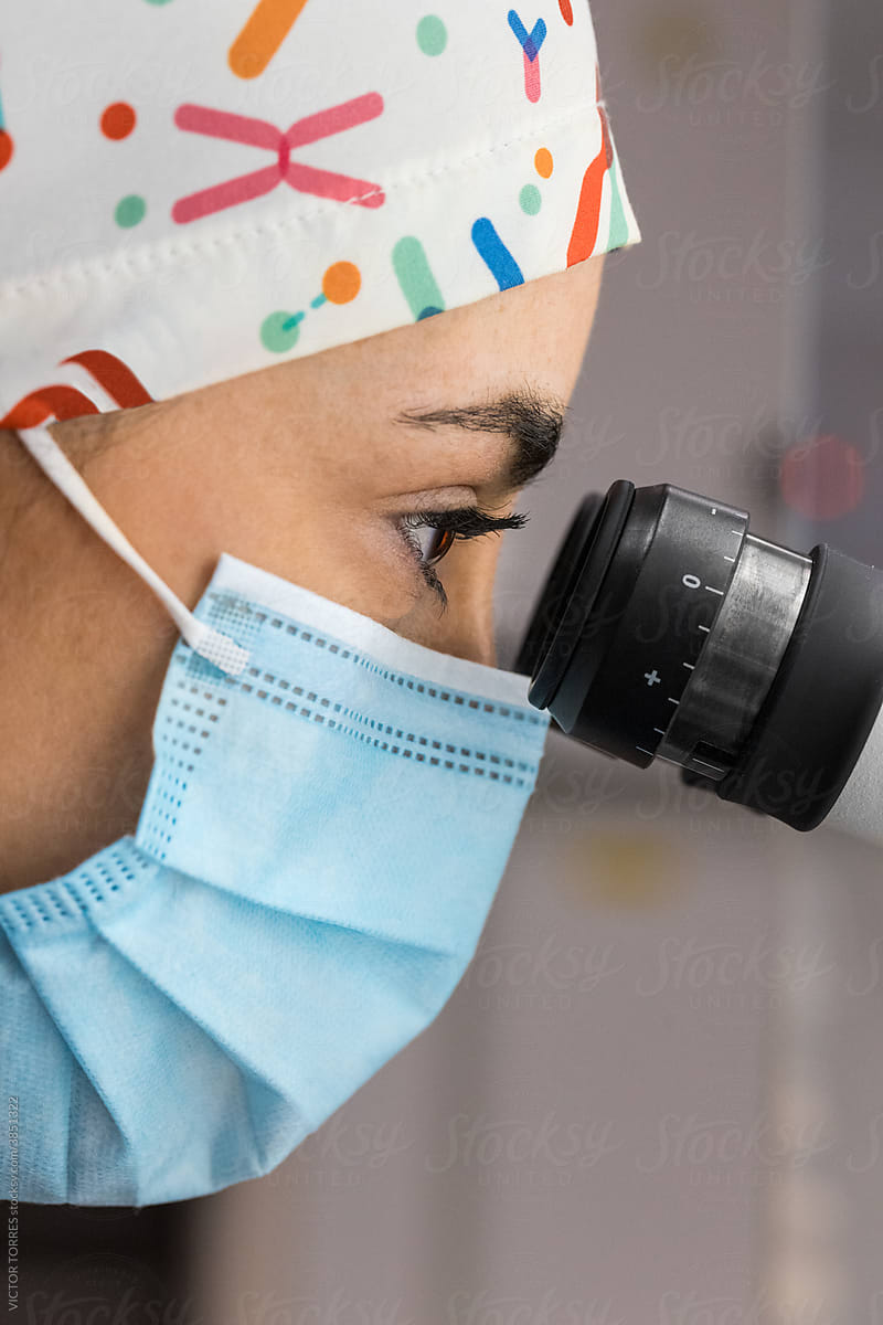 Embryologist with microscope conducting fertilization in lab