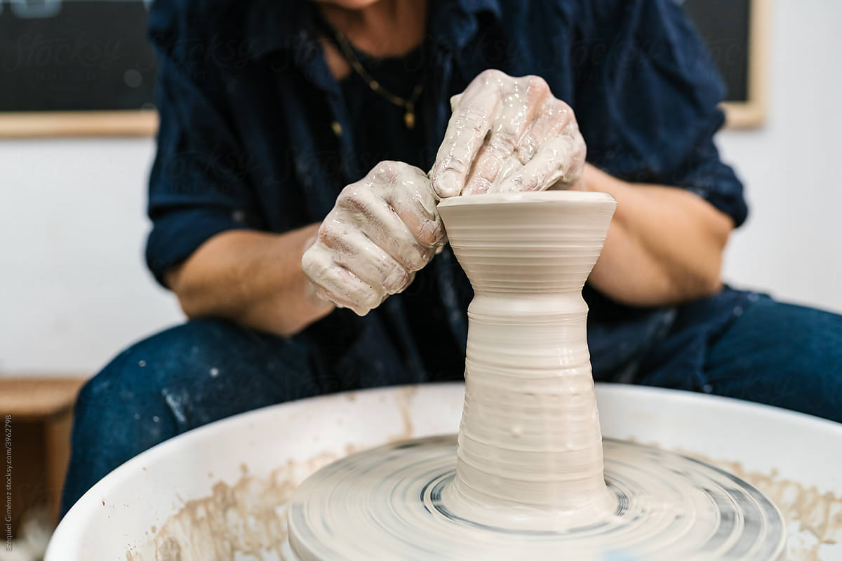 Crop potter creating clay vessel