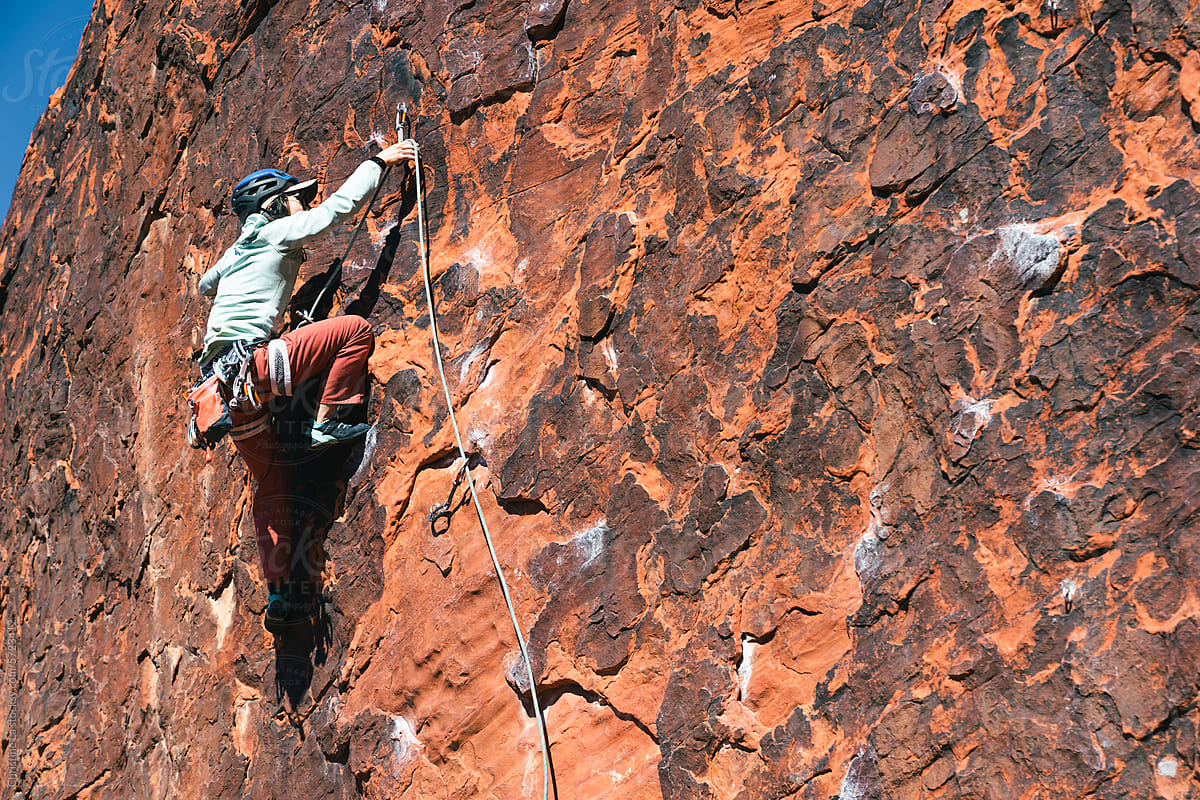 Woman lead rock climbing outdoors