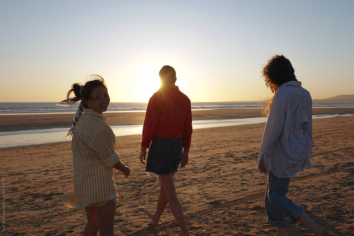 Three young female friends travel on the seaside. Feminism