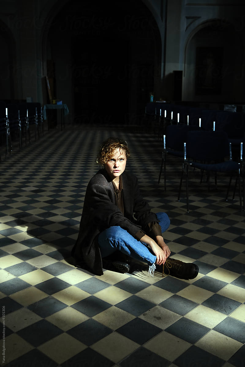 Young woman sitting on the floor in church
