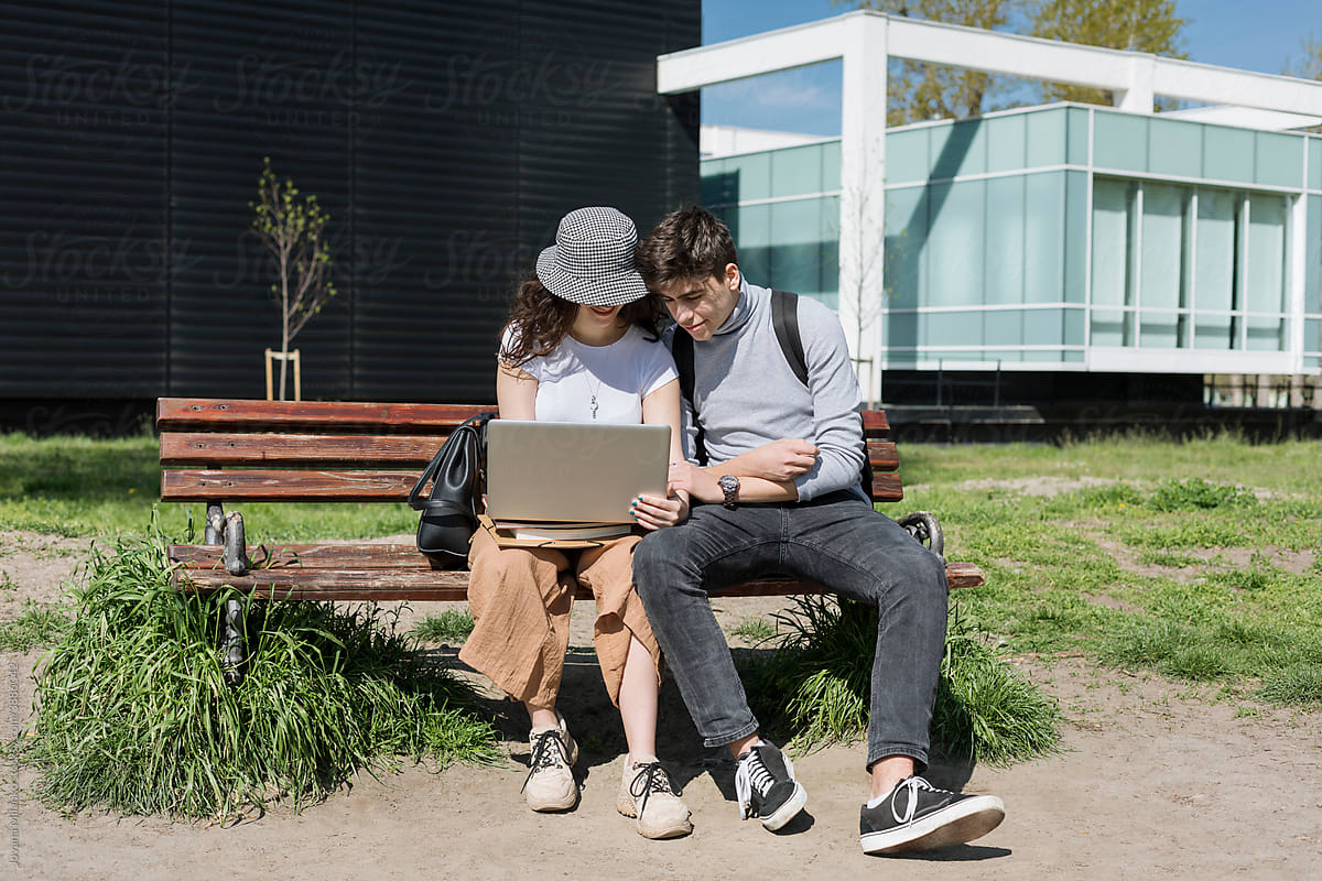 Boy and Girl Student Couple Sharing Laptop