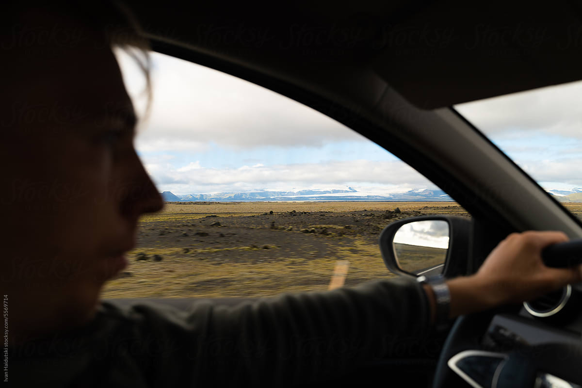 Man driving through Nordic Iceland, surrounded by scenic glacier mount