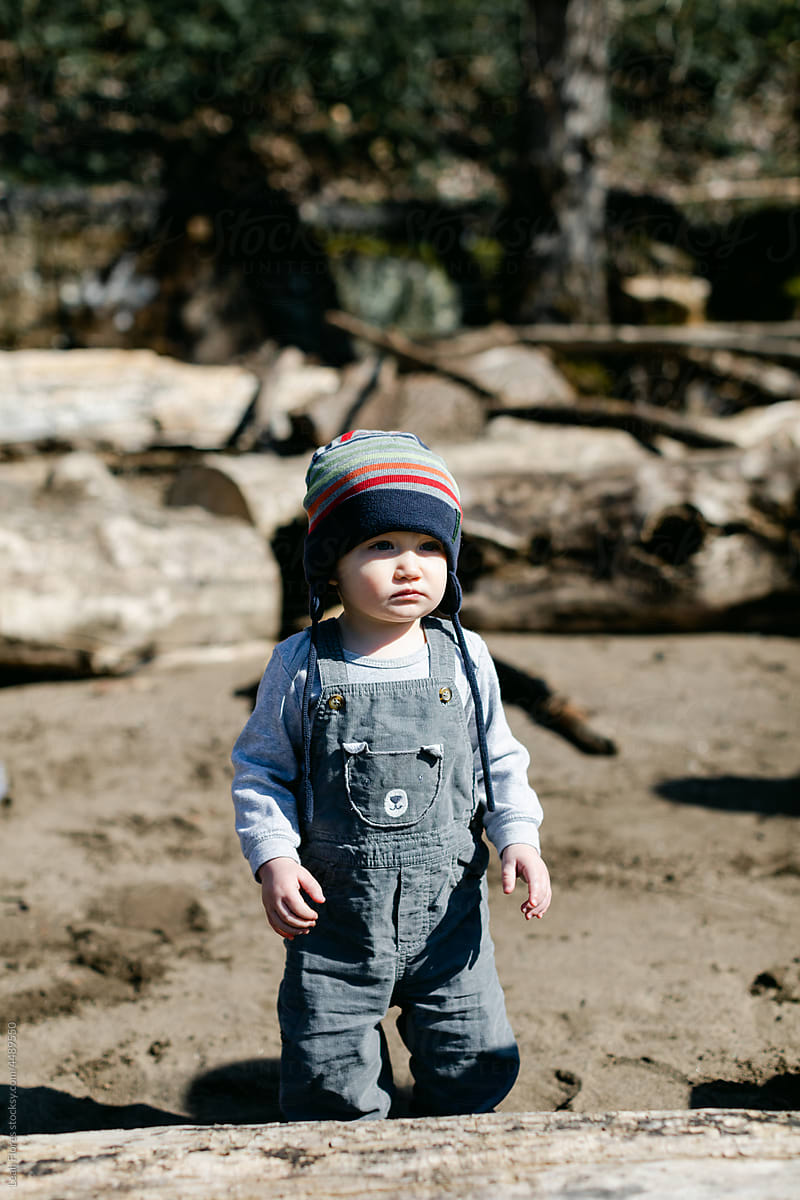 Adorable Little Toddler Standing on Bright Riverbank