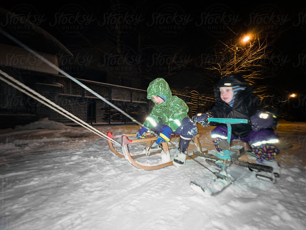 Night sledding, kids outdoors