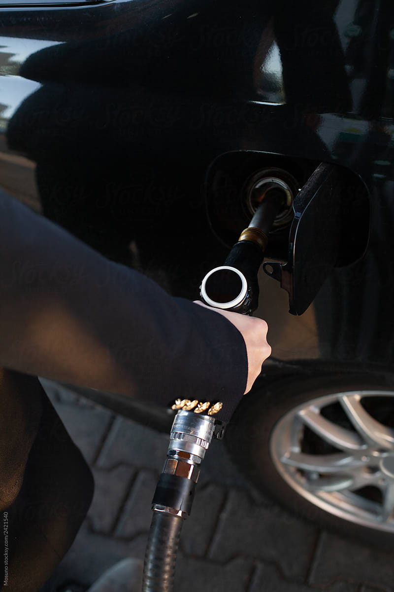 Close up of a man filling his car tank