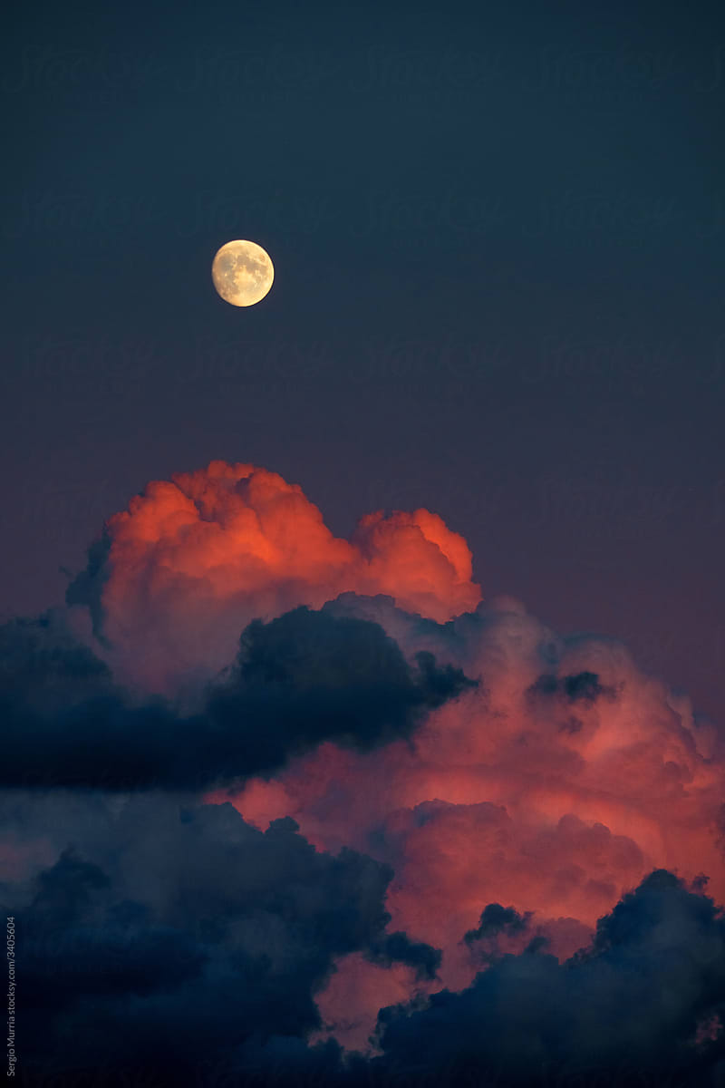 98% full moon with red clouds