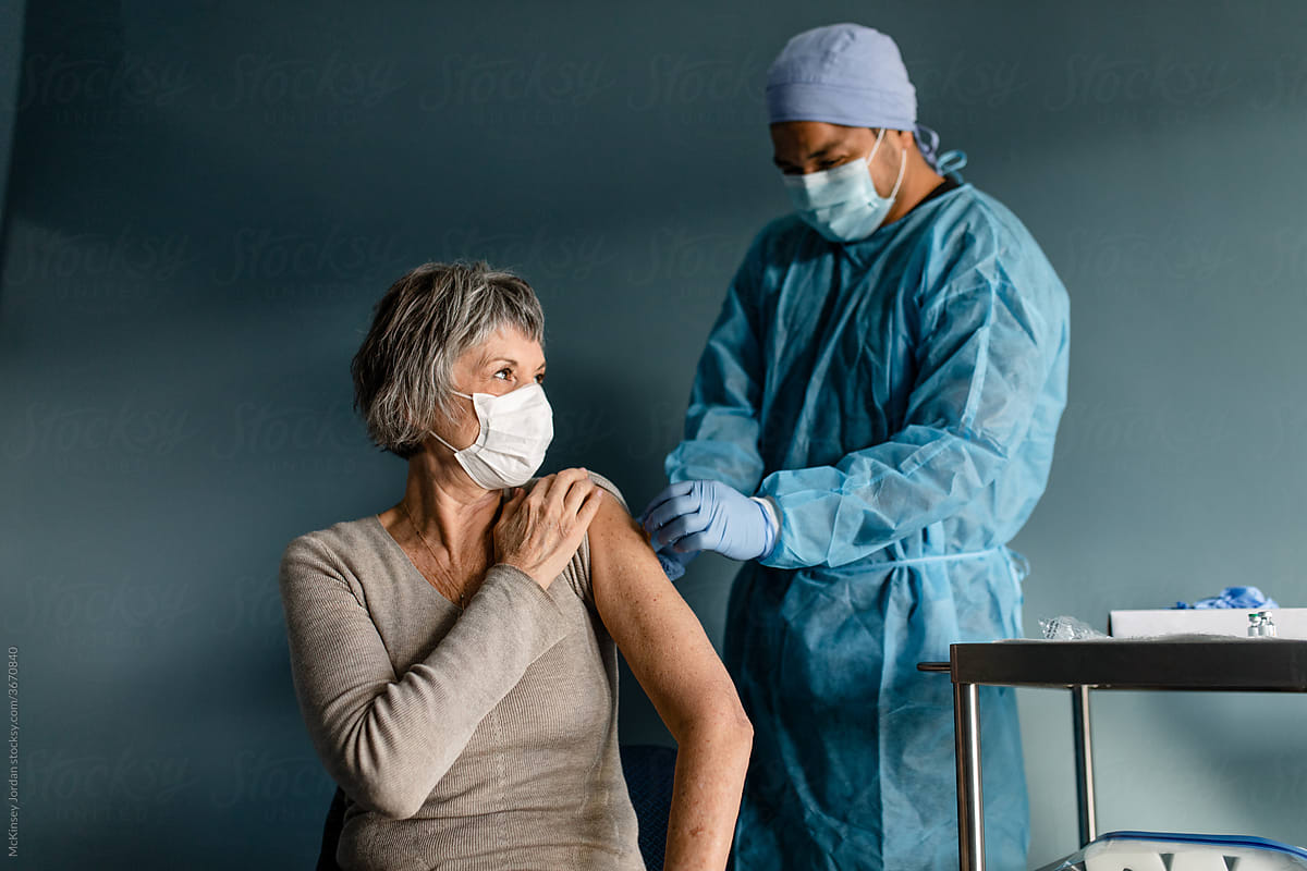 Nurse Puts a Bandage on a Senior Woman\'s Arm