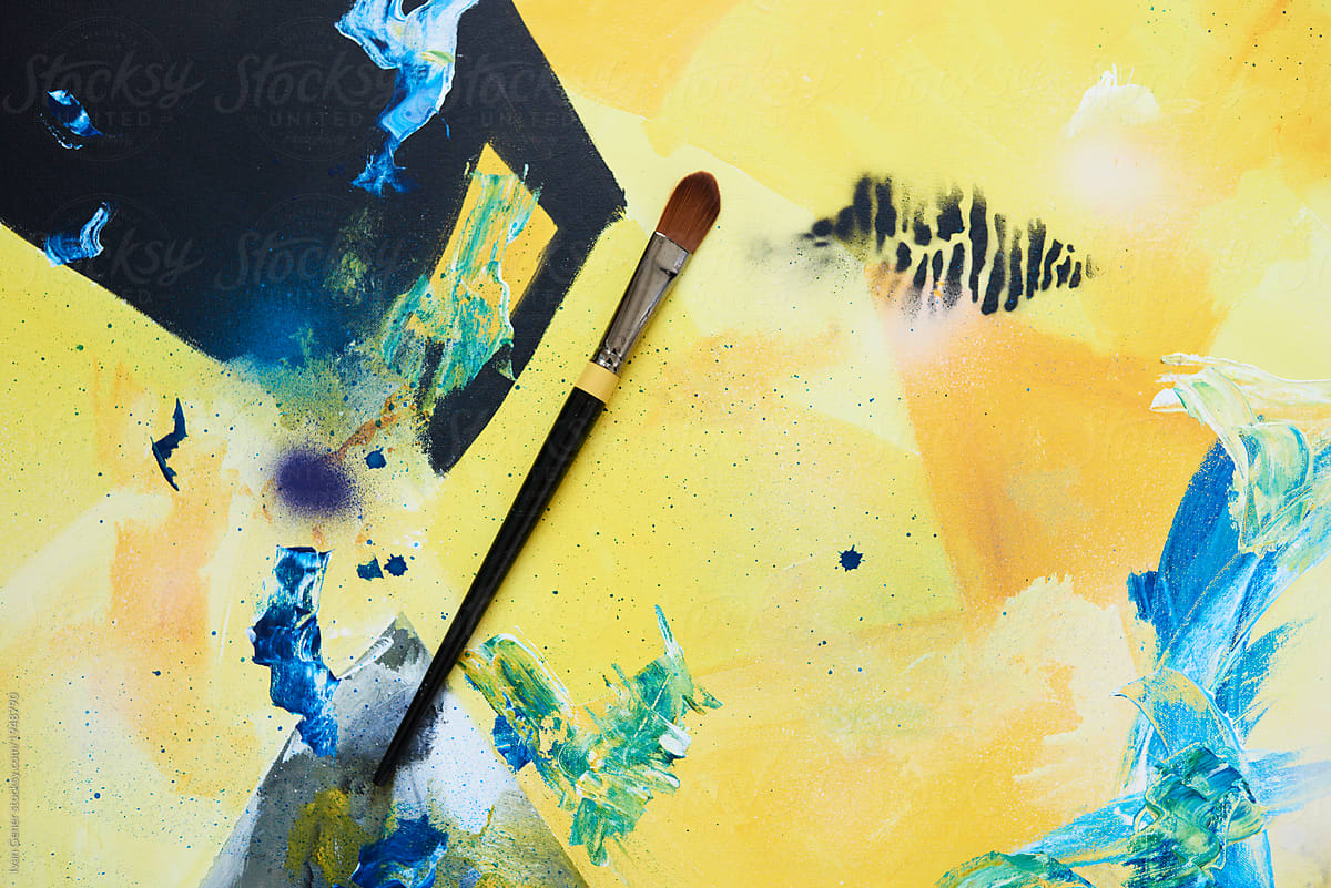 Paintbrush on colorful artwork canvas