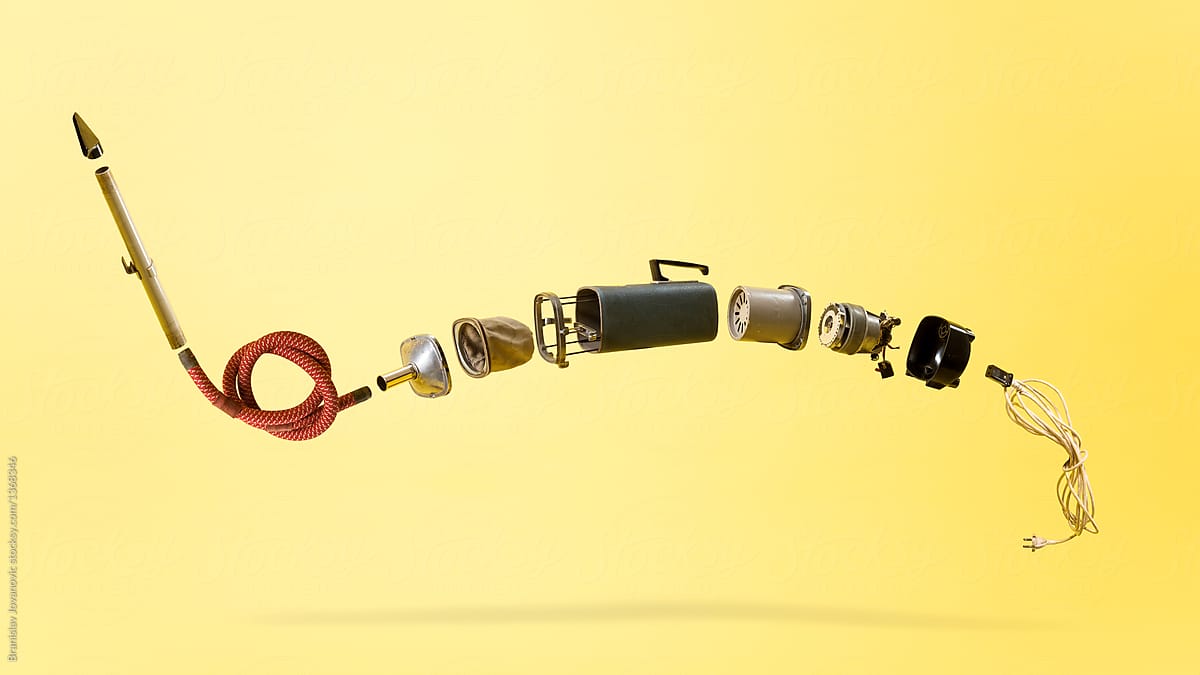 Deconstructed Vacuum Cleaner Against The Yellow Background