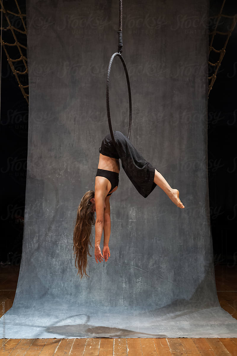 Aerial artist suspended to a Lyra or Aerial hoop 21